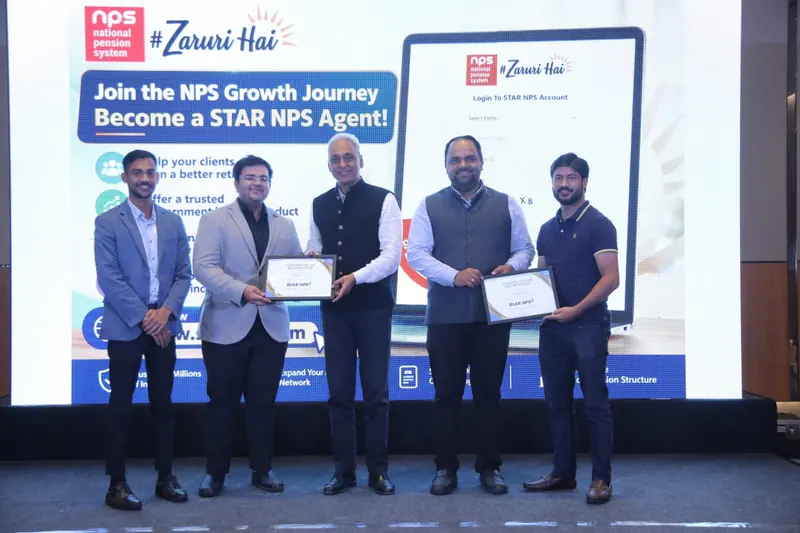 Five people on stage at an NPS event, two holding framed certificates, in front of a screen promoting the STAR NPS Agent programme